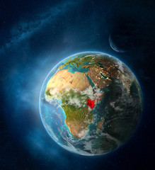 Kenya from space on Earth surrounded by space with Moon and Milky Way. Detailed planet surface with city lights and clouds.