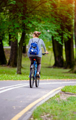 Girl riding a bike in the city Park 