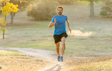 Athletic young man running in the nature at sunset in autumn in fitness Healthy lifestyle