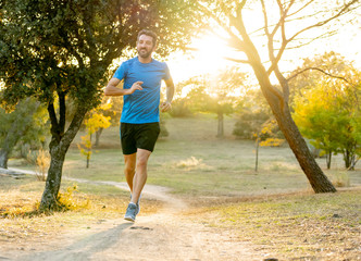 Athletic young man running in the nature at sunset in autumn in fitness Healthy lifestyle