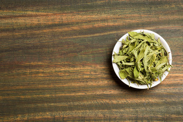 Stevia dried leaves - Stevia rebaudiana. Wood background