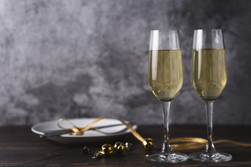 Two glasses of champagne on wooden floor