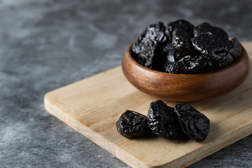 prune in wooden bowl