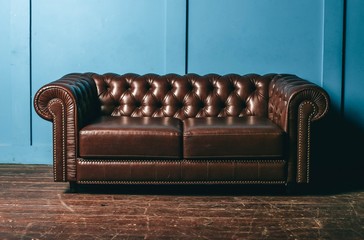 luxurious leather, brown sofa, blue wall. classic vintage furniture.