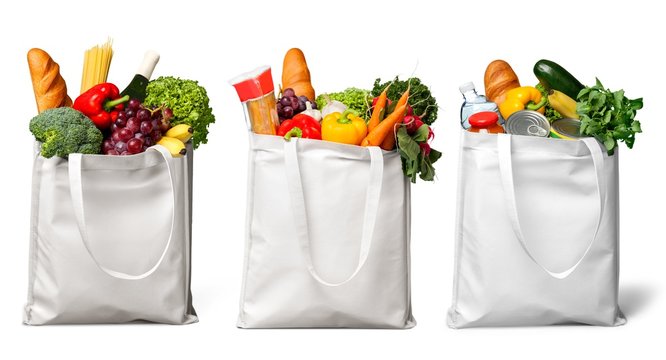 Shopping bags with groceries isolated on white