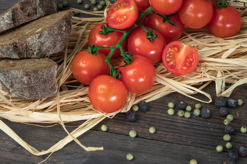 Fresh tomatoes from grapes on a wooden background. in a rustic style. season of vegetables. advertisement.Vegetables from the garden.