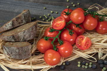 Fresh tomatoes from grapes on a wooden background. in a rustic style. season of vegetables. advertisement.Vegetables from the garden.