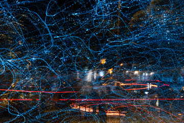 Abstract streaky tree lights and traffic taillights at night in Harrogate,North Yorkshire,England.