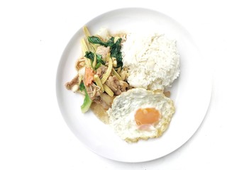 Stir fry chicken, sweet peppers, corn, broccoli, sweet basil and green beans with rice and fried egg in ธhai style in white dish on white background. Thai style food.
