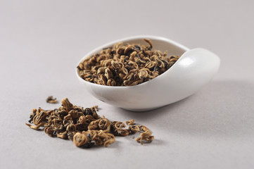 Chinese black tea in tea ware. Infusions. Heap of dry tea leaf.