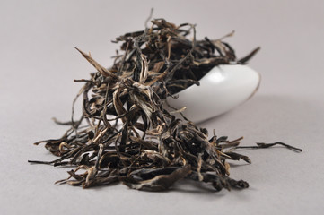 Chinese black tea in tea ware. Infusions. Heap of dry tea leaf.
