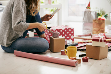 Woman preparing presents for family and friends for Christmas and New Year. Holiday concept.