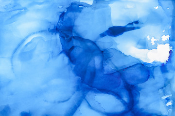 Fototapeta na wymiar blue splashes of alcohol ink as abstract background