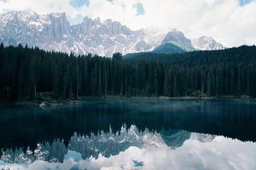The Karersee lake with reflection of mountains in the Dolomites.