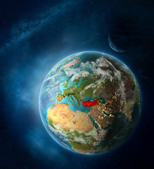 Turkey from space on Earth surrounded by space with Moon and Milky Way. Detailed planet surface with city lights and clouds.