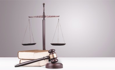 Justice Scales, gavel and books on light background