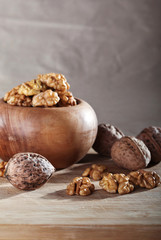Walnuts in a wooden bowl on a wooden board