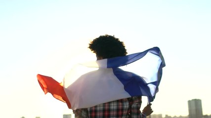 Girl wrapped in national flag standing outdoor, foreign student exchange program