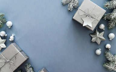 Christmas silver handmade gift boxes on blue background top view. Merry Christmas greeting card, frame. Winter xmas holiday theme. Happy New Year. Flat lay