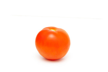 Ripe red tomato on a white background