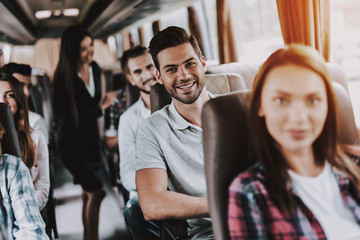 Young Smiling Man Traveling on Tourist Bus