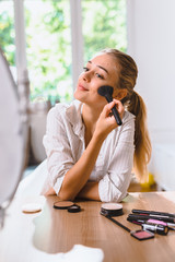 woman doing makeup at home © cherryandbees