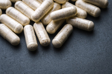 Beige Transparent Drugs, Pills, Vitamins (Dophilus) Scattered On A Gray Slate Background. Medical Series. Angle View. Rustic Style.