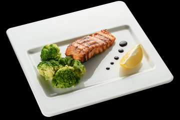 Baked fish salmon garnished with broccoli . Dietary menu. Fish menu. Seafood - salmon.