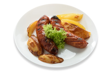 Fried sausages with a vegetable side dish and potatoes. Isolated on white