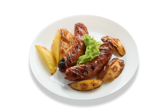 Fried sausages with a vegetable side dish and potatoes. Isolated on white