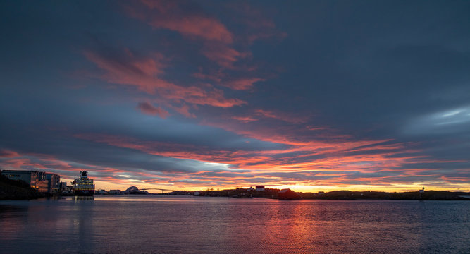 Passenger ship at quay in Brønnøysund with colorful clouds, Nordland county