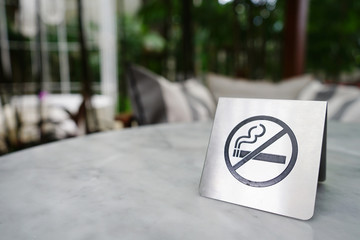 No smoking sign made of stainless on marble table