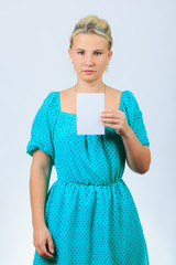 Young blonde girl holds blank brochure