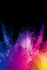 color powder explosion cloud on black background. Freeze motion of color dust  particles splashing. - obrazy, fototapety, plakaty