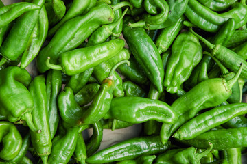 Green bell peppers at the city market stall in France. Top view, flat lay