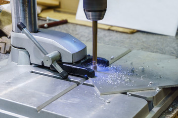 drilling process on small drill press close-up ..