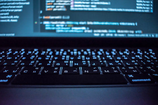 Programming in computer system of programmers in dark room.