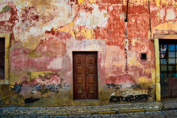 A old building in Portugal in mid summer with a unique paint work