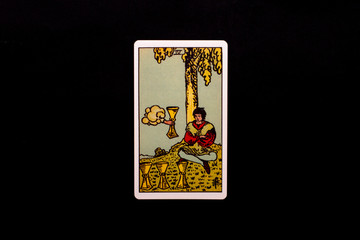 An individual minor arcana tarot card isolated on black background. Four of cups.