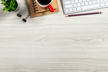 Business workspace Mock up : Desk with laptop,notebook and a cup of coffee. Top view with copy space.