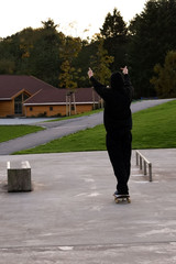 Skateboarding. Platform for skateboarders. The man raised his hands up. A skateboarder pokes his...