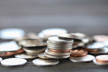 Row of coins on wood background for finance and Saving concept,Investment, Economy, Soft focus and dark style.