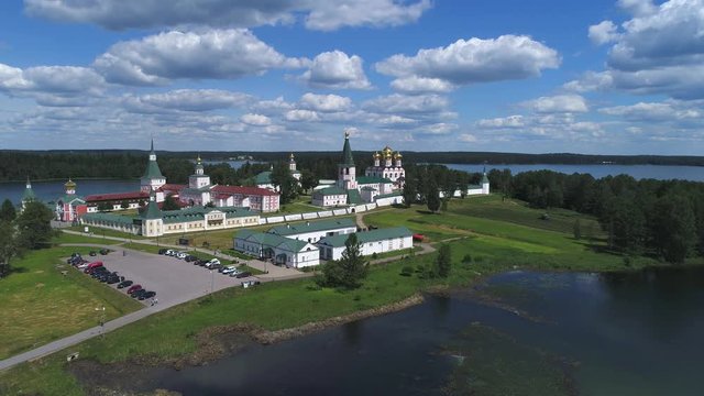 View of the Valdaisky Iversky Bogoroditsky Svyatoozersky monastery, June day (aerial video). Valdai, Russia  