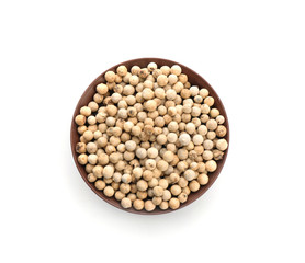 Bowl with pepper grains on white background, top view