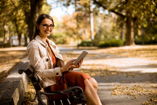 Young woman using digital tablet in the park