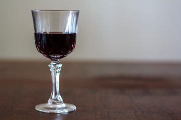 Glass of wine under wooden table