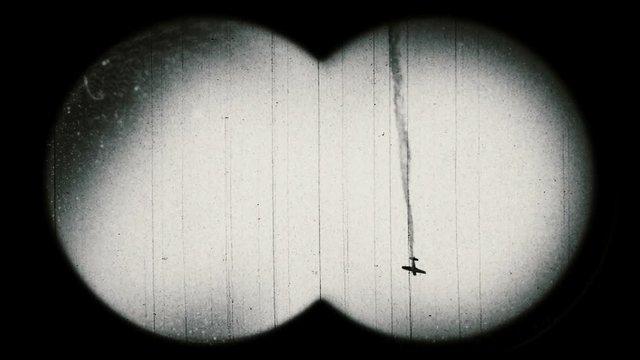 World War II era airplane falling down. Retro style. View through binoculars