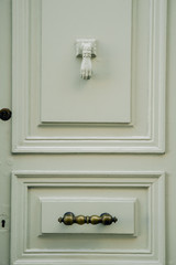 Vintage door knob in a form of a hand on wooden door