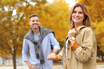 Lovely couple spending time together in park. Autumn walk