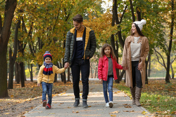 Fototapeta premium Happy family with children spending time together in park. Autumn walk
